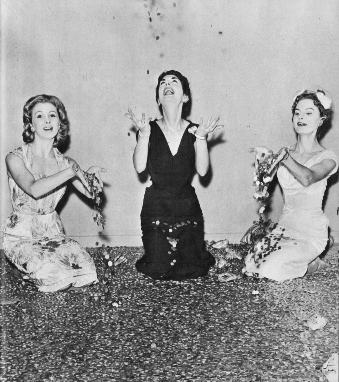 Three women throw shillings into the air